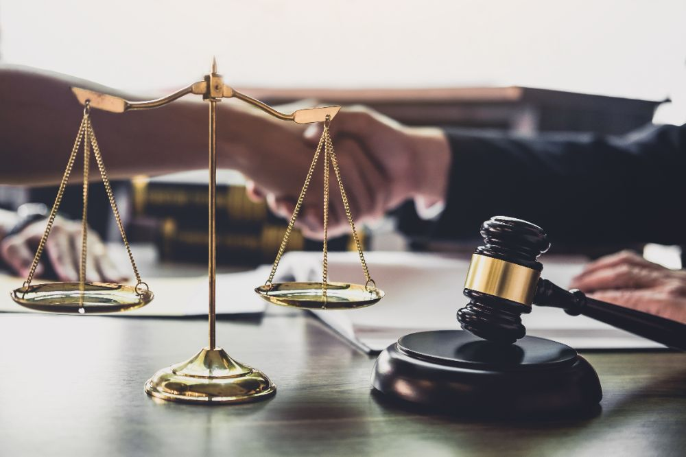 shaking hands in a legal conflict